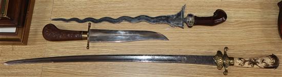 An 18th century and later hunting hanger, a 19th century Kris and an Indian dagger